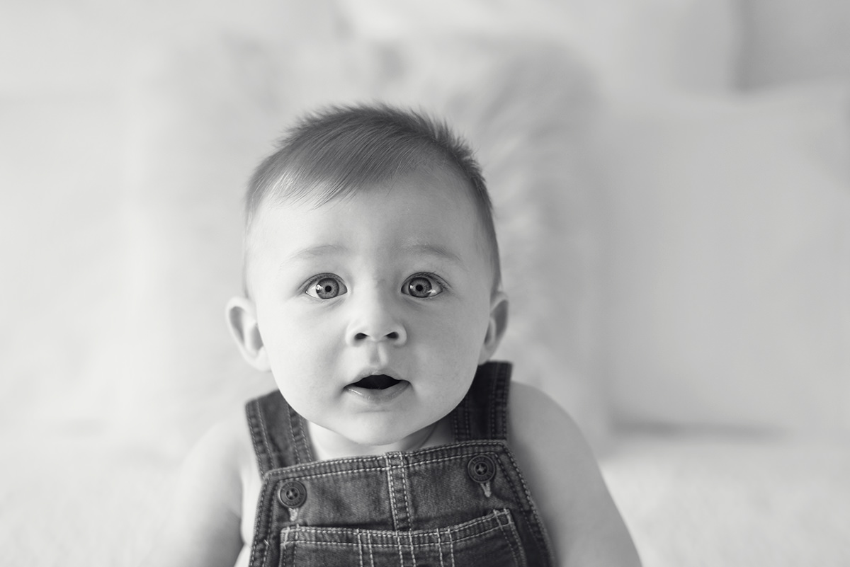Black and white 6 month old baby boy in overalls no shirt