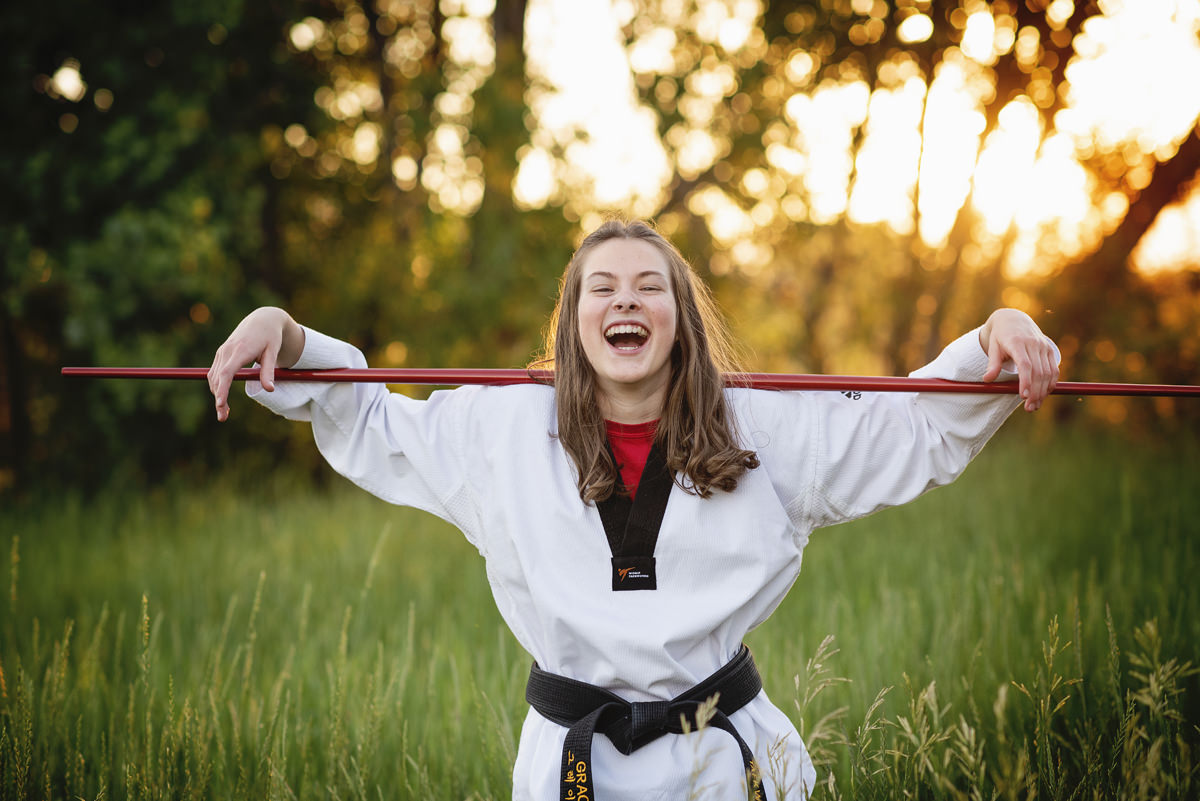 Taekwondo Bo Staff High School Senior Girl Outdoors in Uniform