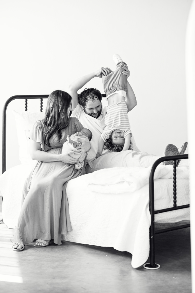 black and white natural light indoor studio newborn session with bed