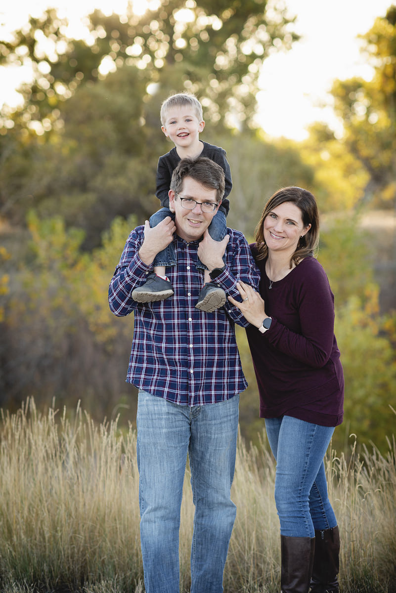 Fall Family outdoor pictures with little boy on dad's shoulders wearing fall colors in their wardrobe