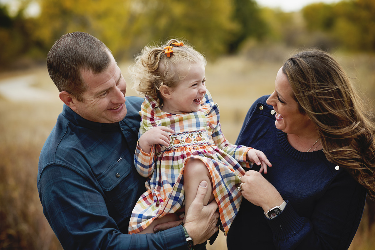 two year old with mom and dad fall photography outdoor