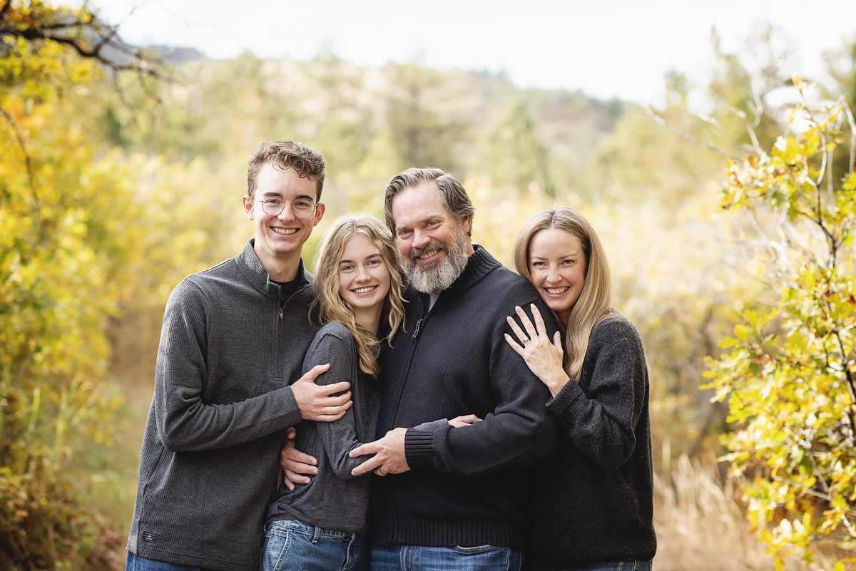 Family hugging professional photography in Castle Rock, Colorado at Dawson Butte