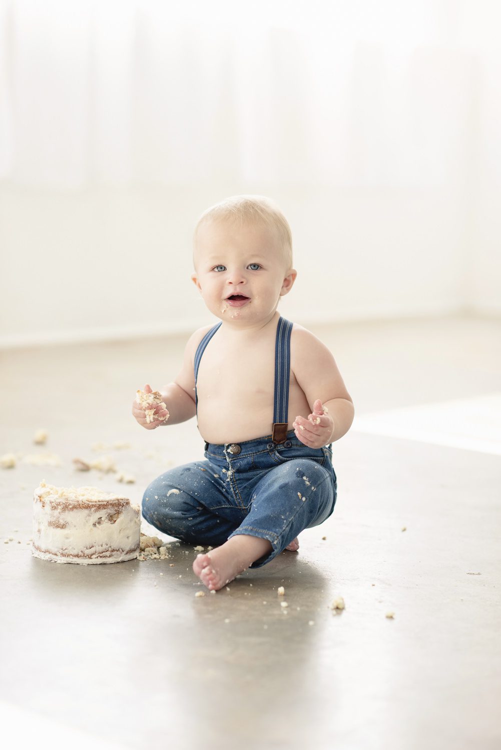 Baby with a birthday cake smashing it taken by Parker, CO Photographer