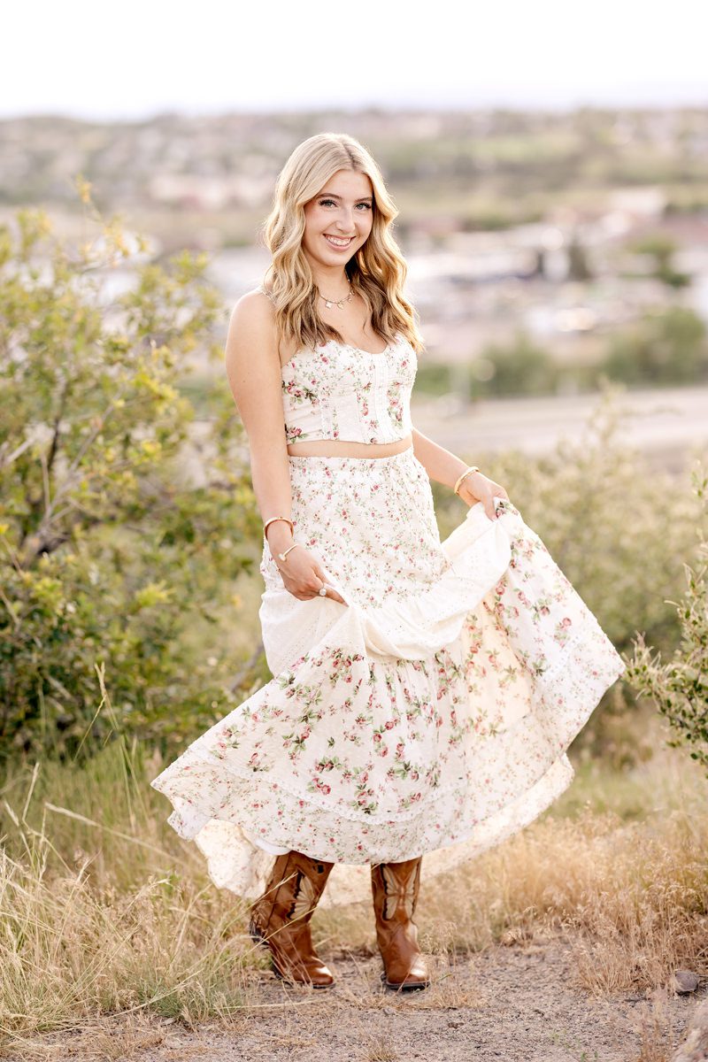 high school senior girl twirling dress for graduation photo for her Parker senior pictures