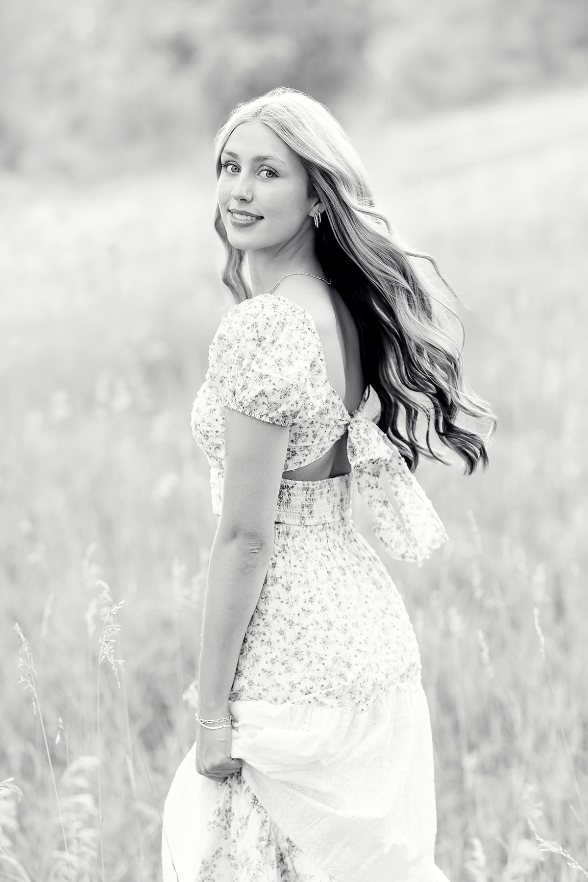black and white photo of a girl twirling and looking at camera for her Parker senior pictures
