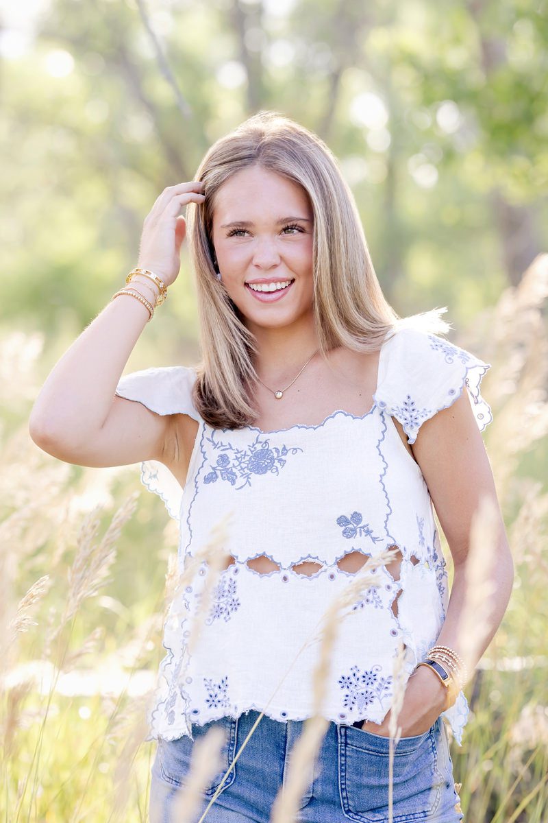 Parker colorado high school senior girl graduation photo of girl brushing out back and laughing lifestyle photo