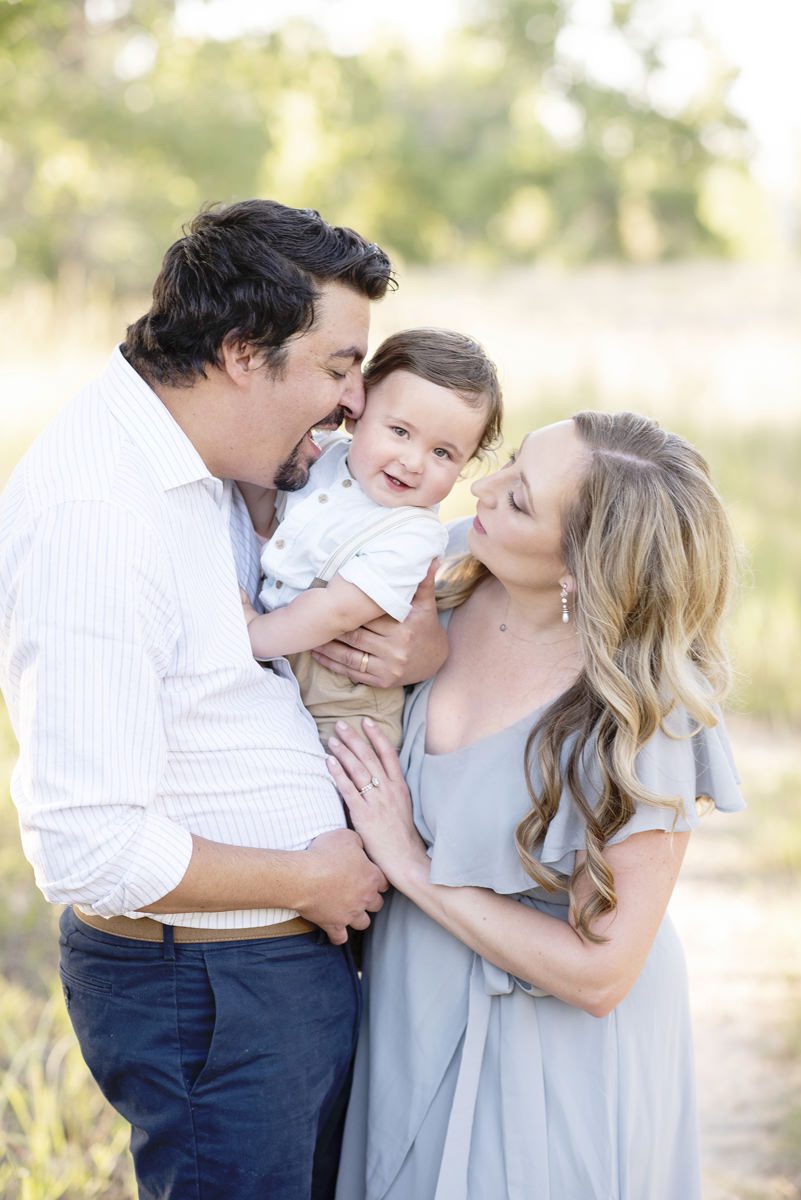 Parker family photographer photo of a mom, dad, and toddler laughing in Colorado