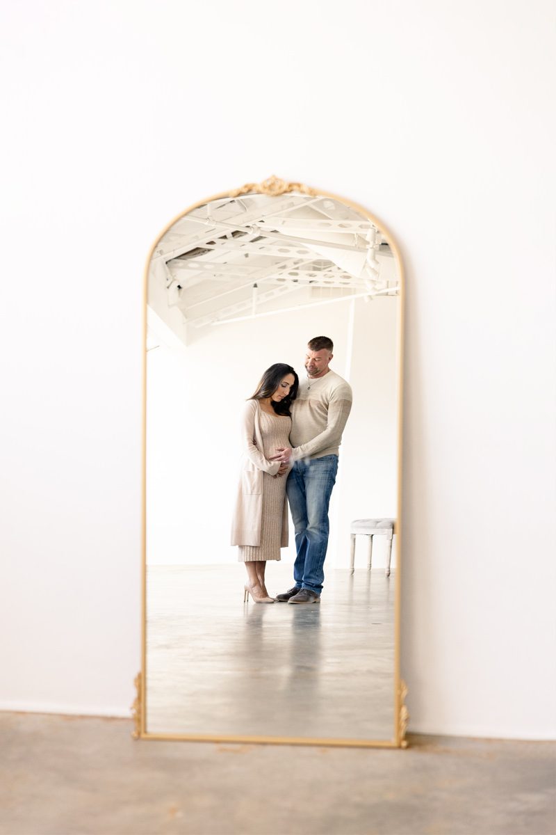 Mirror reflection of a pregnant couple in Parker Colorado