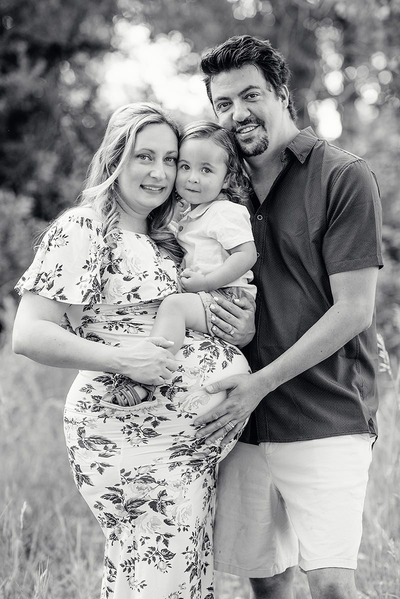 expecting parents with toddler family picture in black and white